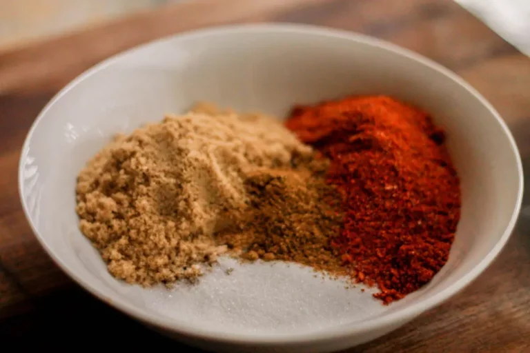 Hasty Bake Asian rub spice blend with brown sugar, paprika and other spices in a white bowl for grilling on a Hasty Bake Charcoal Grill