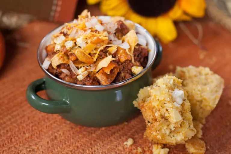 One skillet chorizo beer chili served in a green mug with cornbread, made on a Hasty Bake Charcoal Grill