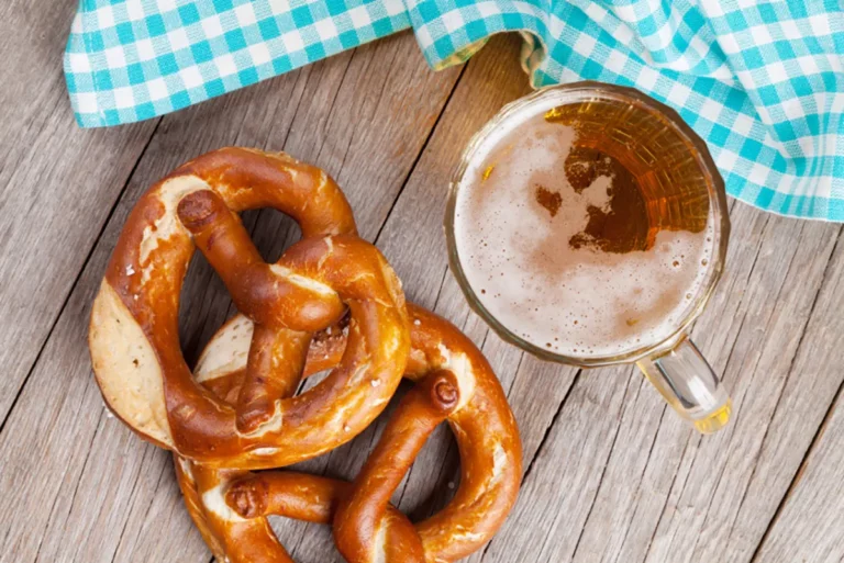 Hasty Bake grilled pretzels with a beer mug on a wooden surface, made on a Hasty Bake Charcoal Grill
