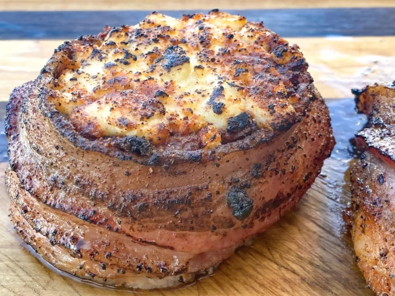 Mushroom stuffed beef filet with cheese filling on a cutting board, cooked on a Hasty Bake Charcoal Grill