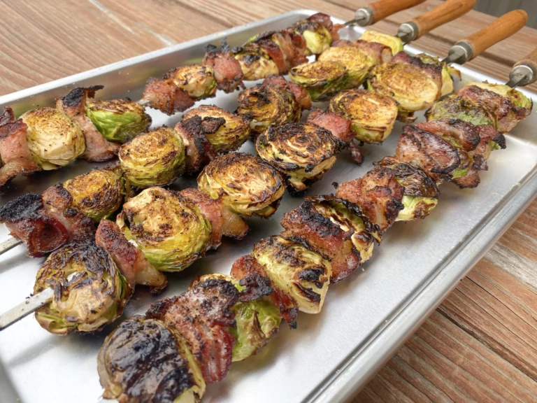 Skewered bacon Brussels sprouts on a baking tray, grilled on a Hasty Bake Charcoal Grill