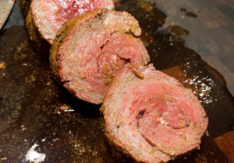 Sliced Wagyu rib cap steak showing beautiful marbling, grilled on a Hasty Bake Charcoal Grill