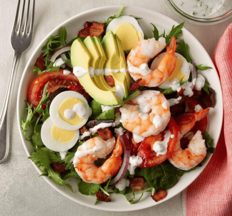 Grilled shrimp cobb salad with avocado, hard-boiled eggs, bacon, tomatoes and ranch dressing on greens, made with shrimp grilled on a Hasty Bake Charcoal Grill